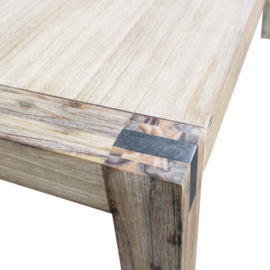 Close-up of a large dining table with solid acacia wooden base and oak color, showcasing the craftsmanship and minimal design.