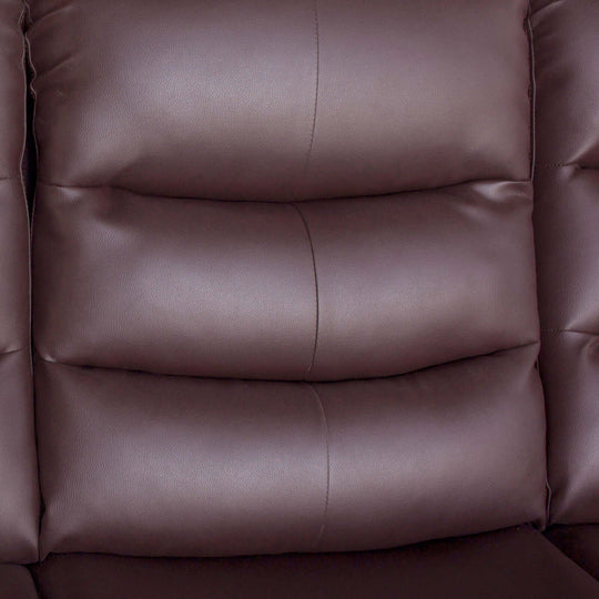 Close-up of plush brown faux leather upholstery on a recliner sofa, highlighting luxurious cushioning and quilted design.