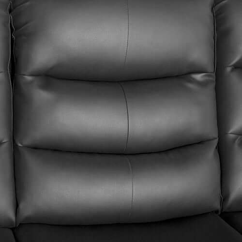 Close-up of black faux leather upholstery with plush cushioning on a recliner sofa, showcasing luxury and comfort.