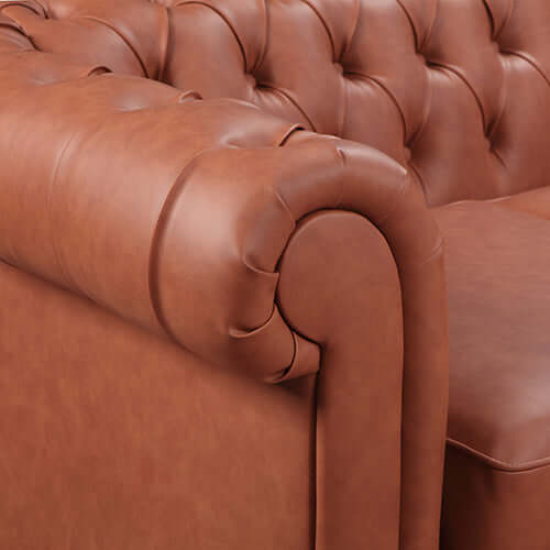 Close-up of button tufted arm of a brown faux leather sofa showcasing its luxurious and affordable design.