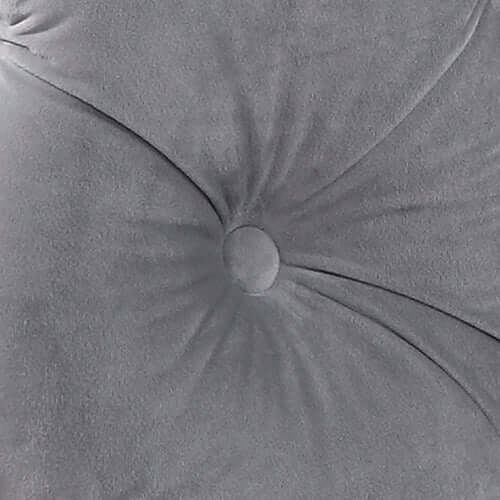 Close-up of classic button tufting on grey velvet fabric for an elegant sofa design, showcasing quality craftsmanship.