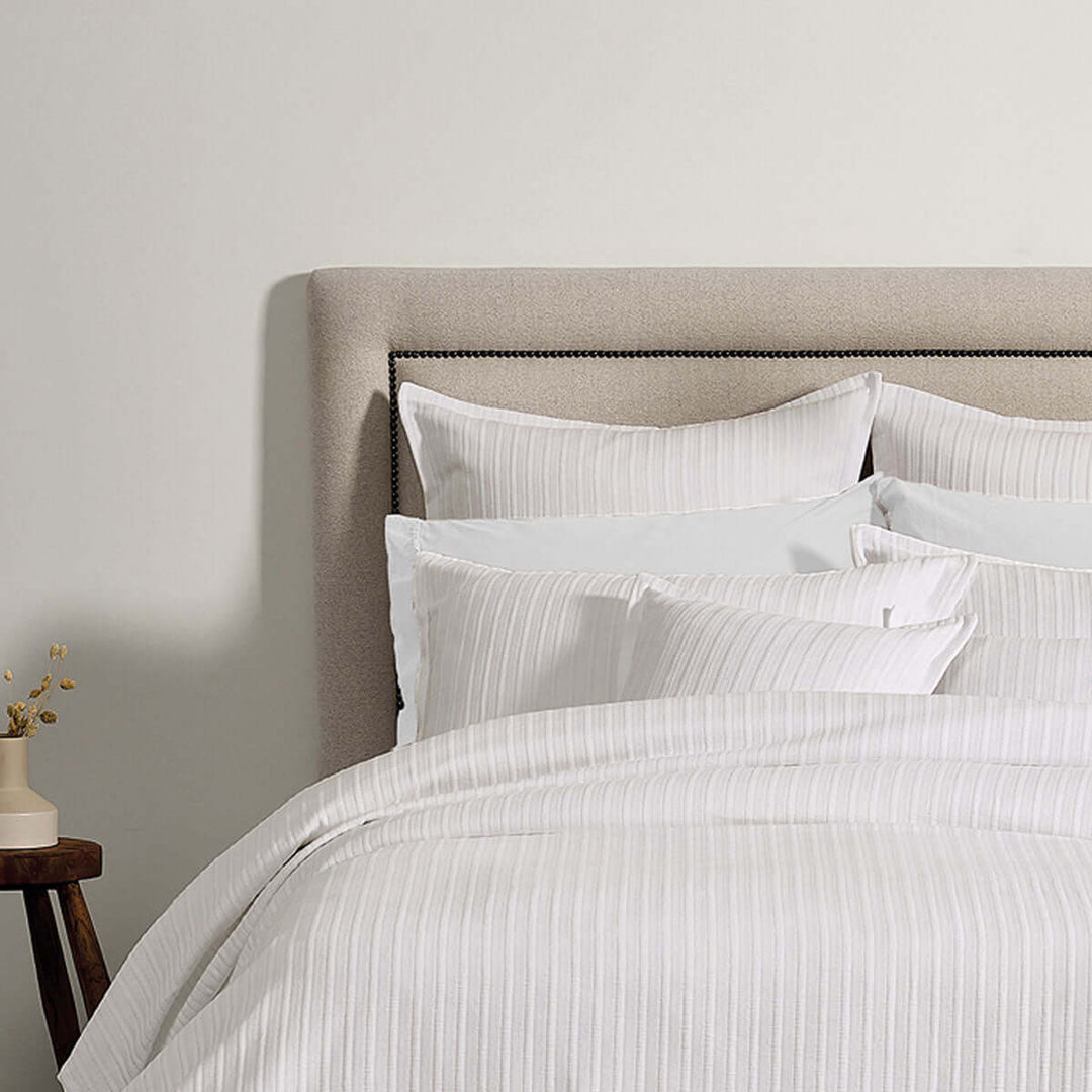 Bianca Evora White Cotton Jacquard Coverlet Set on bed, showcasing luxury design and intricate detailing, affordable and DIY luxe.