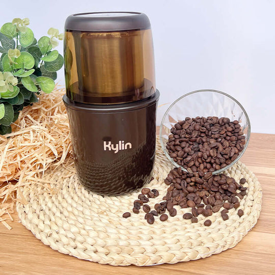 Kylin electric coffee grinder with coffee beans on a woven mat, showcasing affordable and quality kitchen appliance.