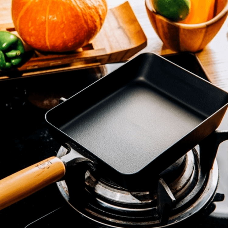 TAKUMI Tamagoyaki small fry pan on stove, showcasing affordable quality for DIY cooking and luxurious meal preparation.