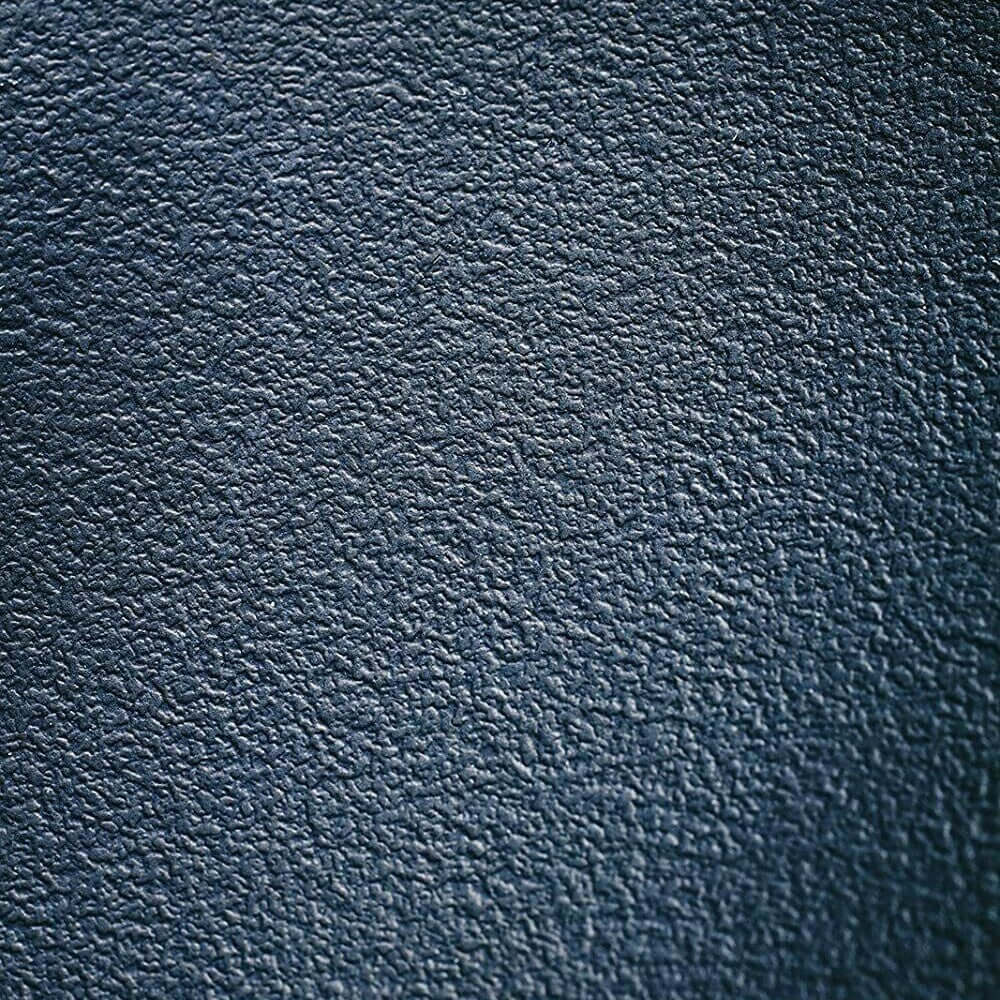 Close-up of textured dark blue material showcasing a rich, luxurious surface ideal for upholstery or DIY projects.