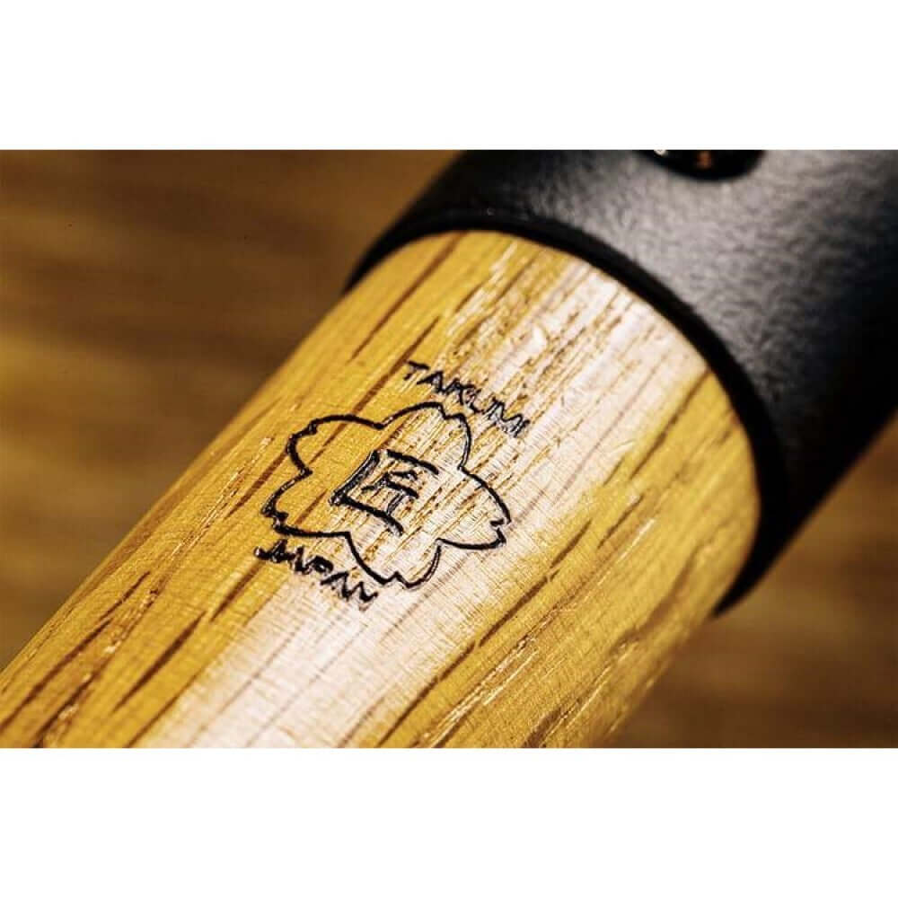 Takumi Premium Magma Plate logo on a wooden handle, showcasing quality craftsmanship made in Japan.