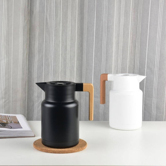 Kylin Japanese vacuum jug in black and white on a table, showcasing affordable quality and sleek design.