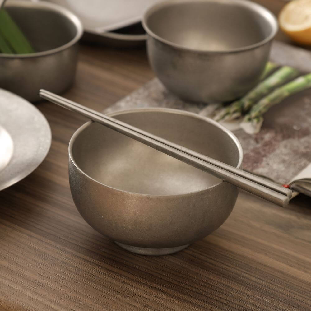 Elegant snow gray bowl with stainless steel chopsticks, perfect for affordable and quality dining experiences.