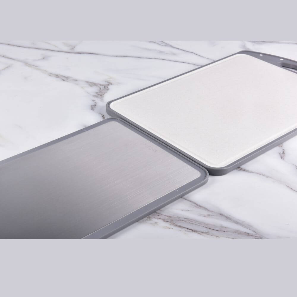 Kylin 316 stainless steel double side cutting board on a marble surface, showcasing its durable design and versatility.