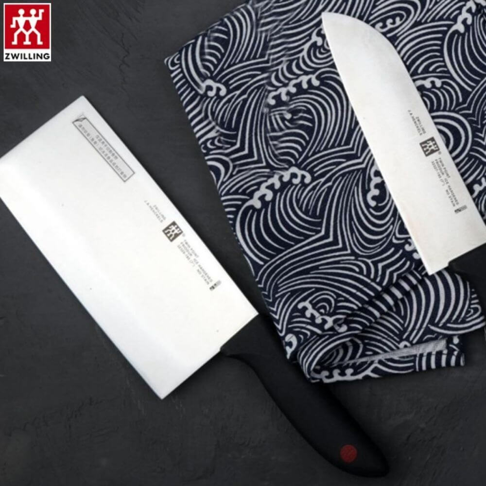 Zwilling ZW-K12 Twin Point Chef's Knife set featuring a Chinese chef's knife and Santoku knife on a patterned cloth.