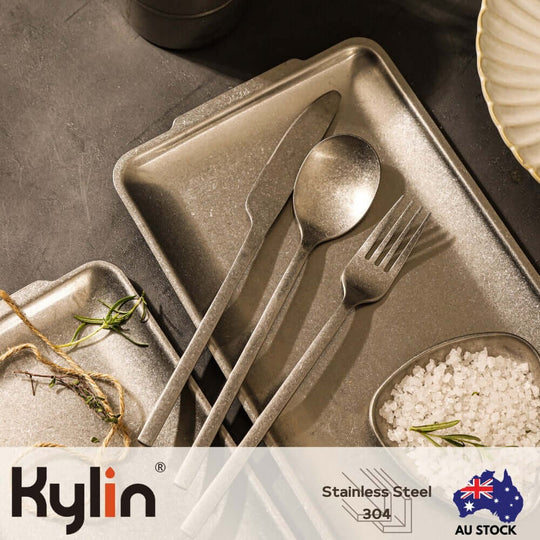 Kylin Stainless Steel 304 cutlery set on a textured tray, featuring a knife, fork, and spoon for quality dining.