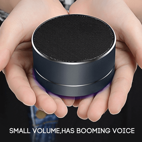 Portable Bluetooth speaker fits in hand, delivers booming sound with elegant design and LED light, ideal for outdoor and indoor use.