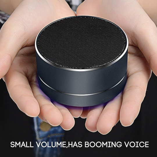 Portable Bluetooth speaker in hand, showcasing its elegant design and powerful sound in a compact size.