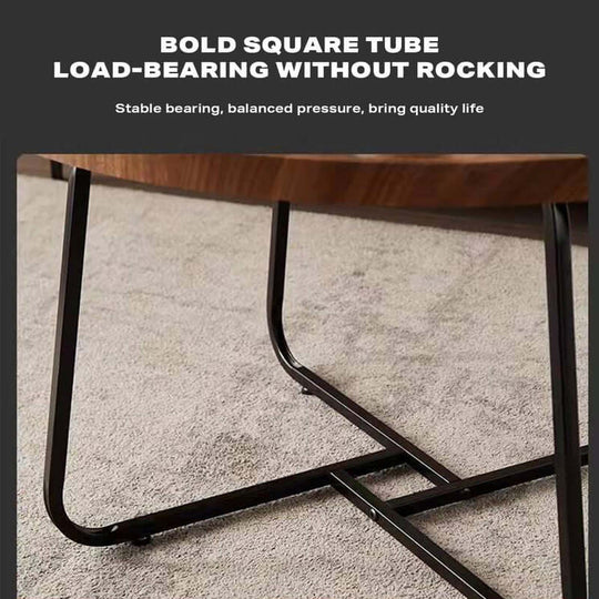 Bold square tube legs of round coffee table, providing stable, load-bearing support without rocking on carpeted floor.