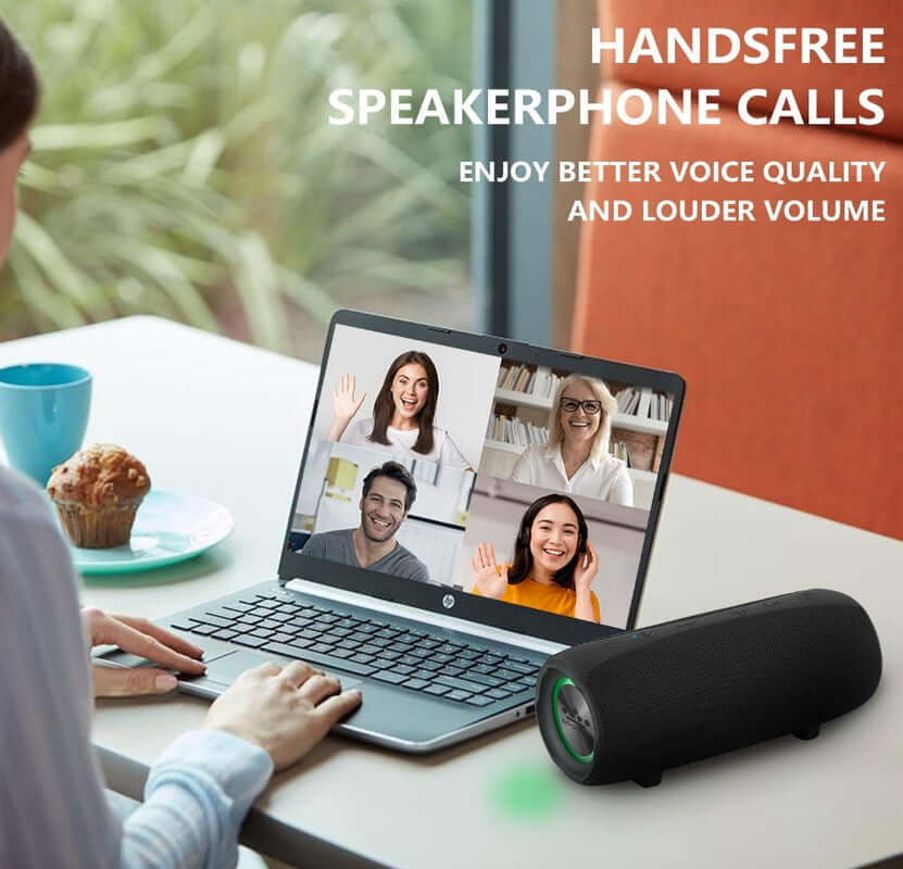 Handsfree speakerphone calls with improved voice quality, featuring a Bluetooth speaker and a laptop in a cozy setting.