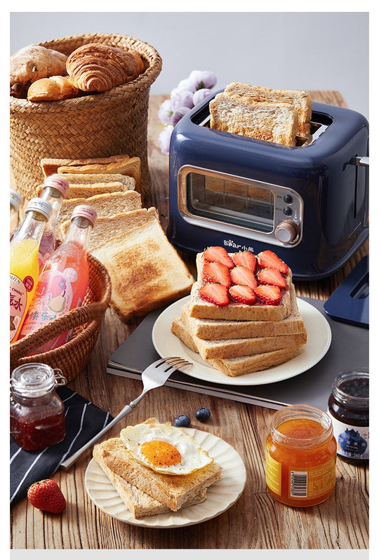 BEAR Double Slots Bread Toaster With Glass Window DSL-C02X1 on a table with toasted bread, jam, drinks, and breakfast items.