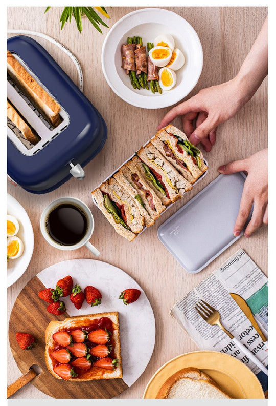 Preparing breakfast with BEAR Double Slots Bread Toaster, sandwich with fresh vegetables and fruits, coffee, and newspaper.