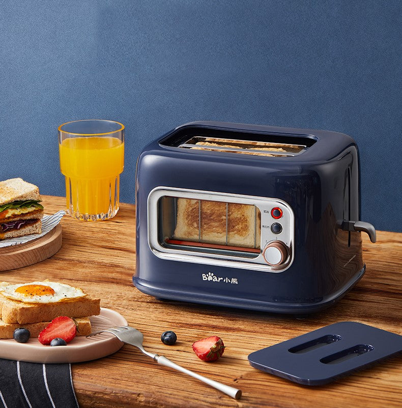 BEAR Double Slots Bread Toaster with Glass Window DSL-C02X1 on a wooden kitchen counter, shown with breakfast items, orange juice, and toast.