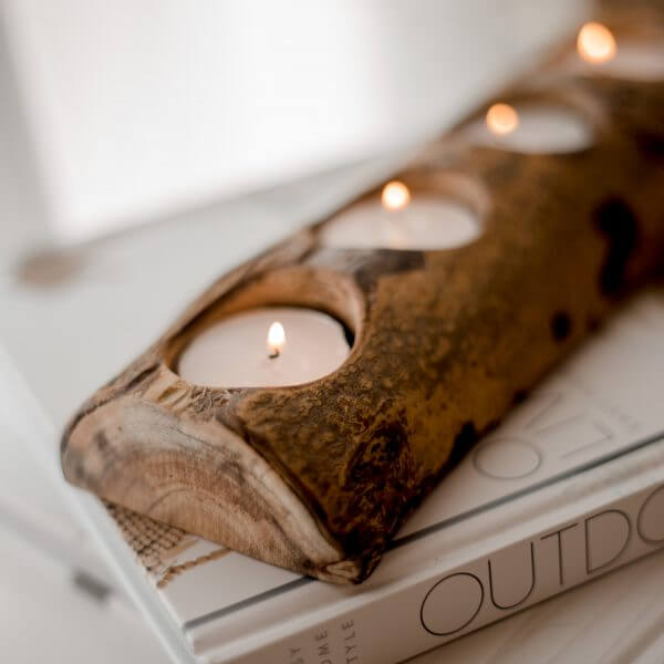 Natural wood candle holder with 4 holes, perfect for tea lights, adding a cozy touch to any room.