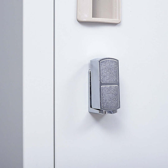 Close-up of a stylish chrome lock on a one-door office gym shed locker cabinet for secure storage.