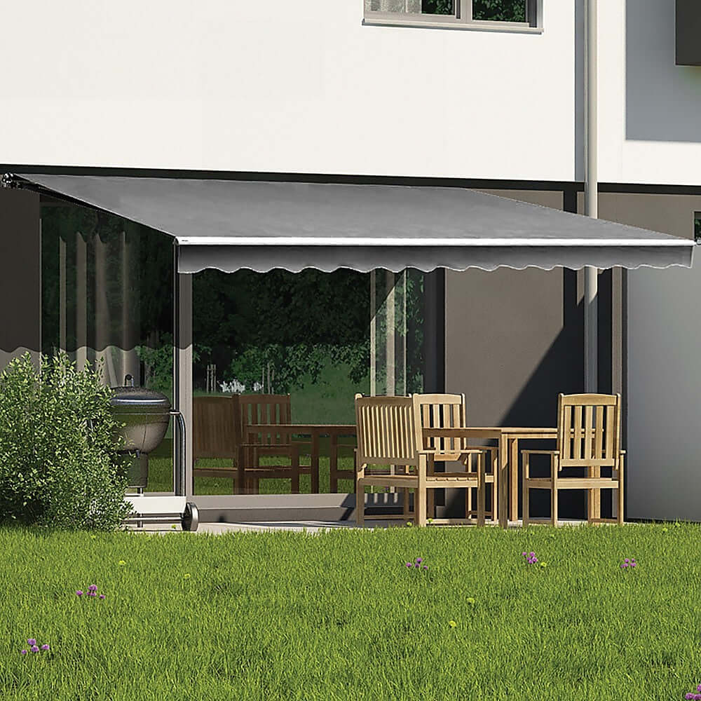 Outdoor grey retractable awning over patio with wooden furniture, offering summer sun protection, affordable quality solution.