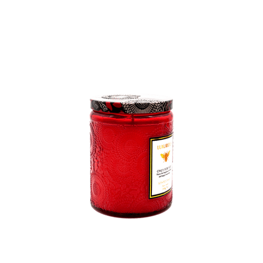 Affordable luxury Faubourg embossed scented candle in red glass, enhancing home decor with quality and elegance.