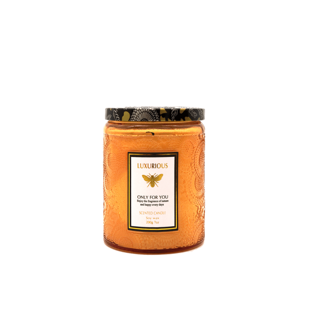 Faubourg Embossed Scented Candle in amber glass, a quality and affordable decor piece for any luxe interior.