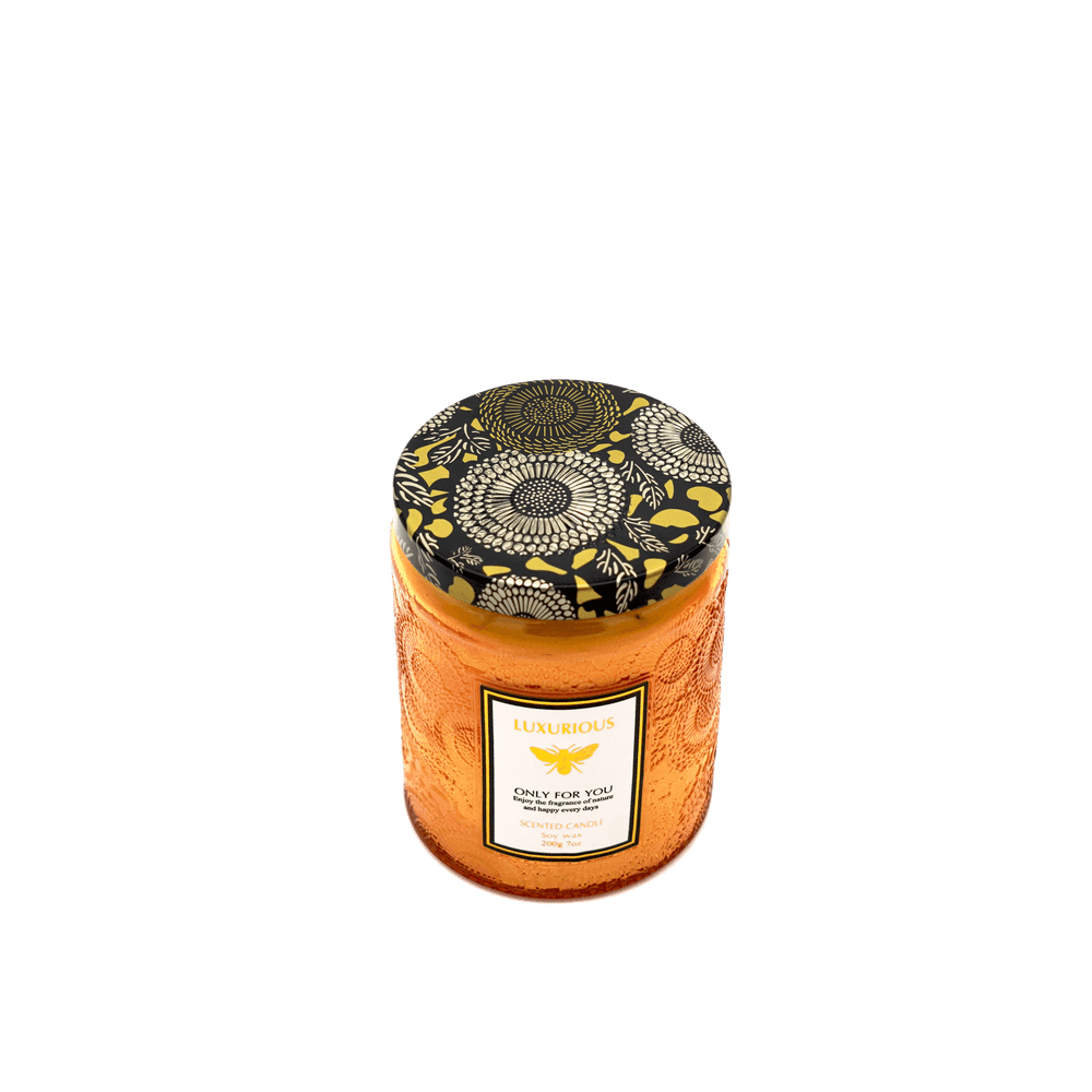 Faubourg embossed scented candle in amber glass with decorative lid, perfect for affordable luxury decor.