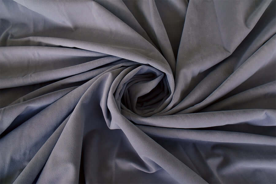 Soft, high-quality purple grey velvet fabric, ideal for DIY curtains or home decor projects, showcasing a luxurious texture.