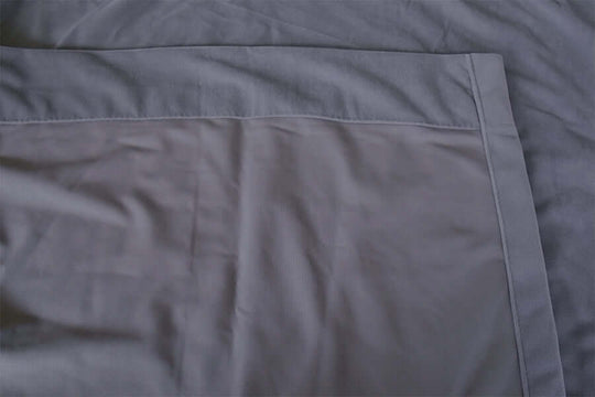 Close-up of soft grey velvet fabric, showcasing high-quality blockout curtain material, ideal for DIY home decor.