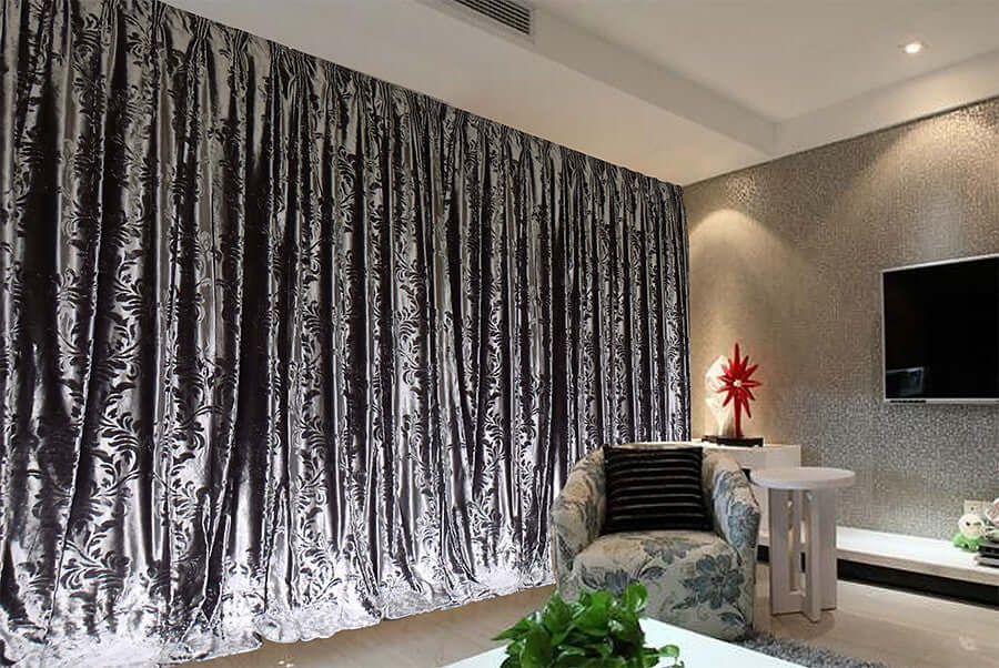 Luxurious silver grey thick velvet curtains enhancing modern living room decor with elegant texture and design.