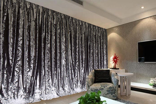 Luxurious silver grey thick velvet curtains enhancing modern living room decor with elegant texture and design.