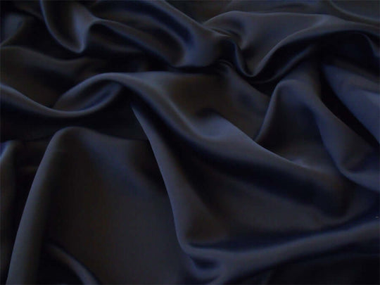 Luxurious black blackout curtain fabric, soft and wrinkle-resistant, made from high-thread count polyester, ideal for DIY home decor projects.