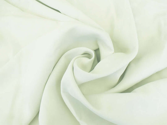 Milk white fabric close-up, showcasing soft, silk-like texture, ideal for affordable and luxe DIY curtain projects.