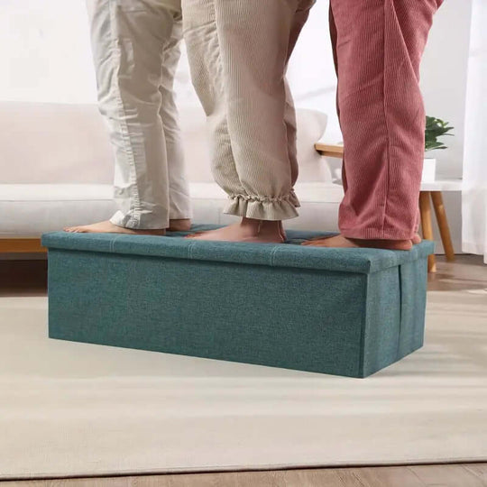 Two people standing on a durable Morandi Green storage stool, demonstrating its functionality and style for organizing spaces.