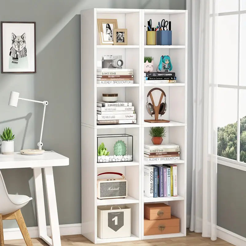 White 6-tier cube display shelves for home office, filled with books, decor, and various items, next to a desk in a contemporary room.