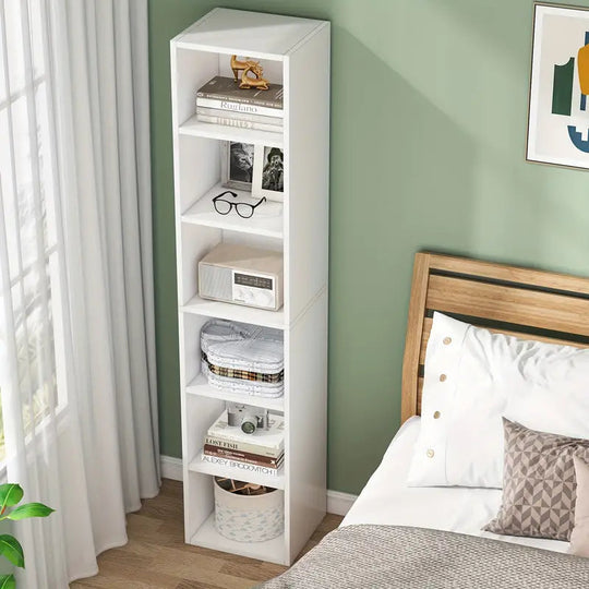 6-Tier white NNETMLT cube display shelves in a contemporary home office, showcasing books and decor next to a bed. Affordable quality value furniture.