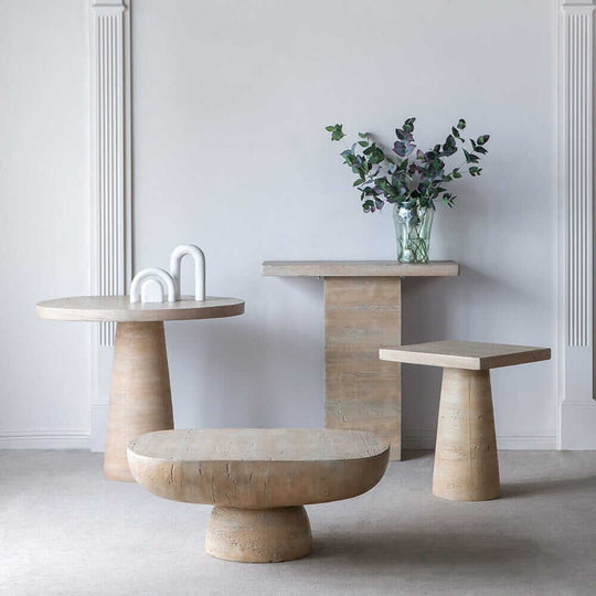 Modern cement side tables in a minimalist setting, showcasing affordable luxe decor for stylish interiors.