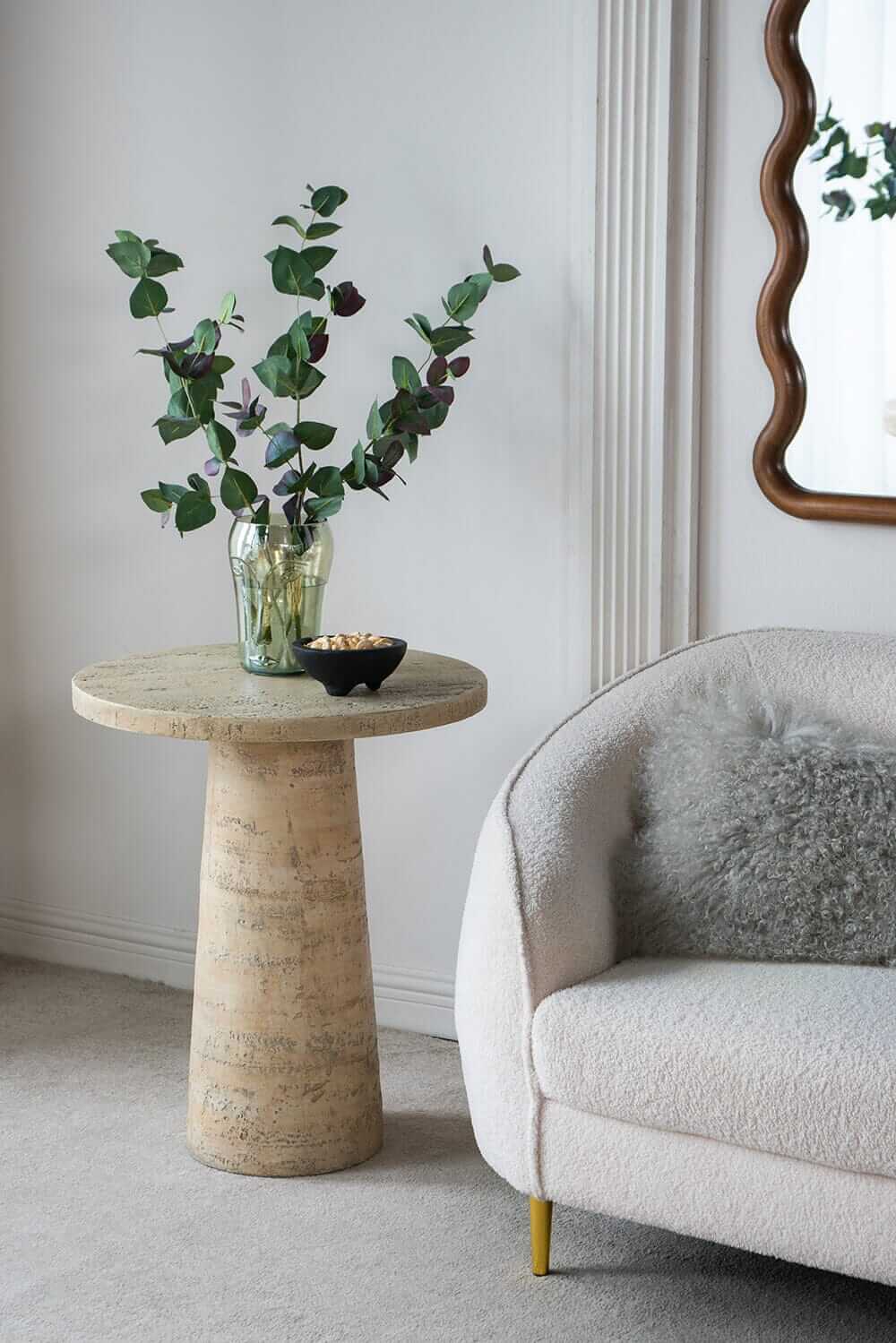 Logan cement round side table with greenery and decorative bowl, enhancing modern home decor with luxe appeal.