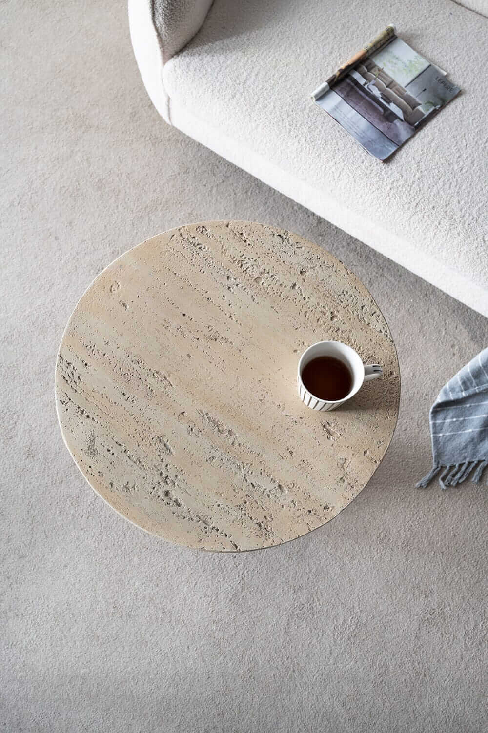 LOGAN CEMENT ROUND SIDE TABLE with a cup of tea and a cozy blanket, adding luxe style to modern home decor.