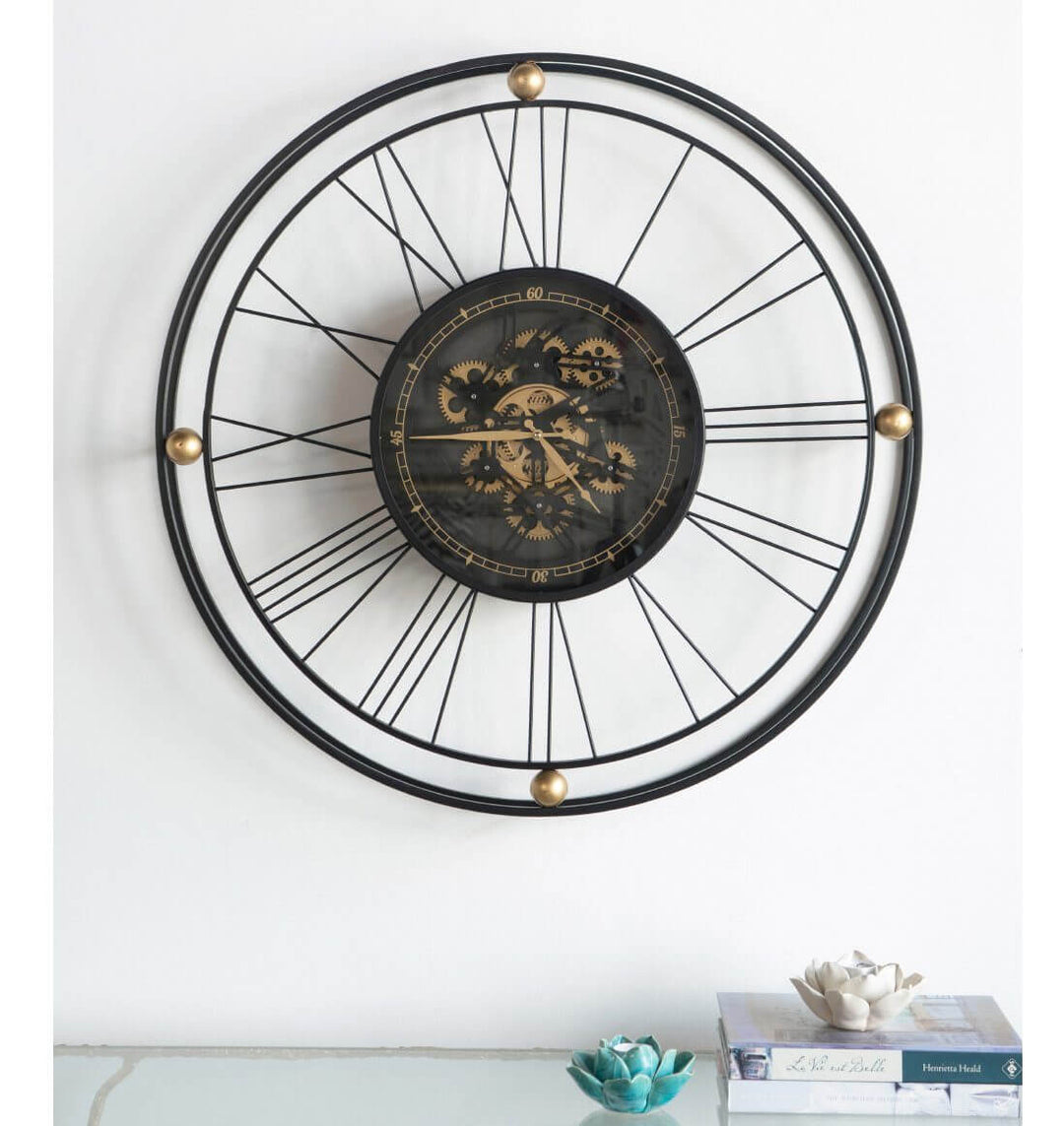 Traveler wall clock with moving 3D mechanism and oversized Roman numerals, adding a luxe touch to minimal interiors.