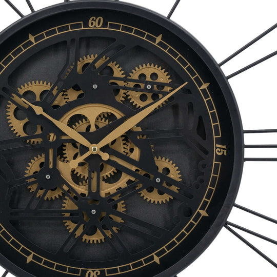 Traveler wall clock close-up showing moving 3D gears and oversized Roman numerals for a luxe, industrial look.