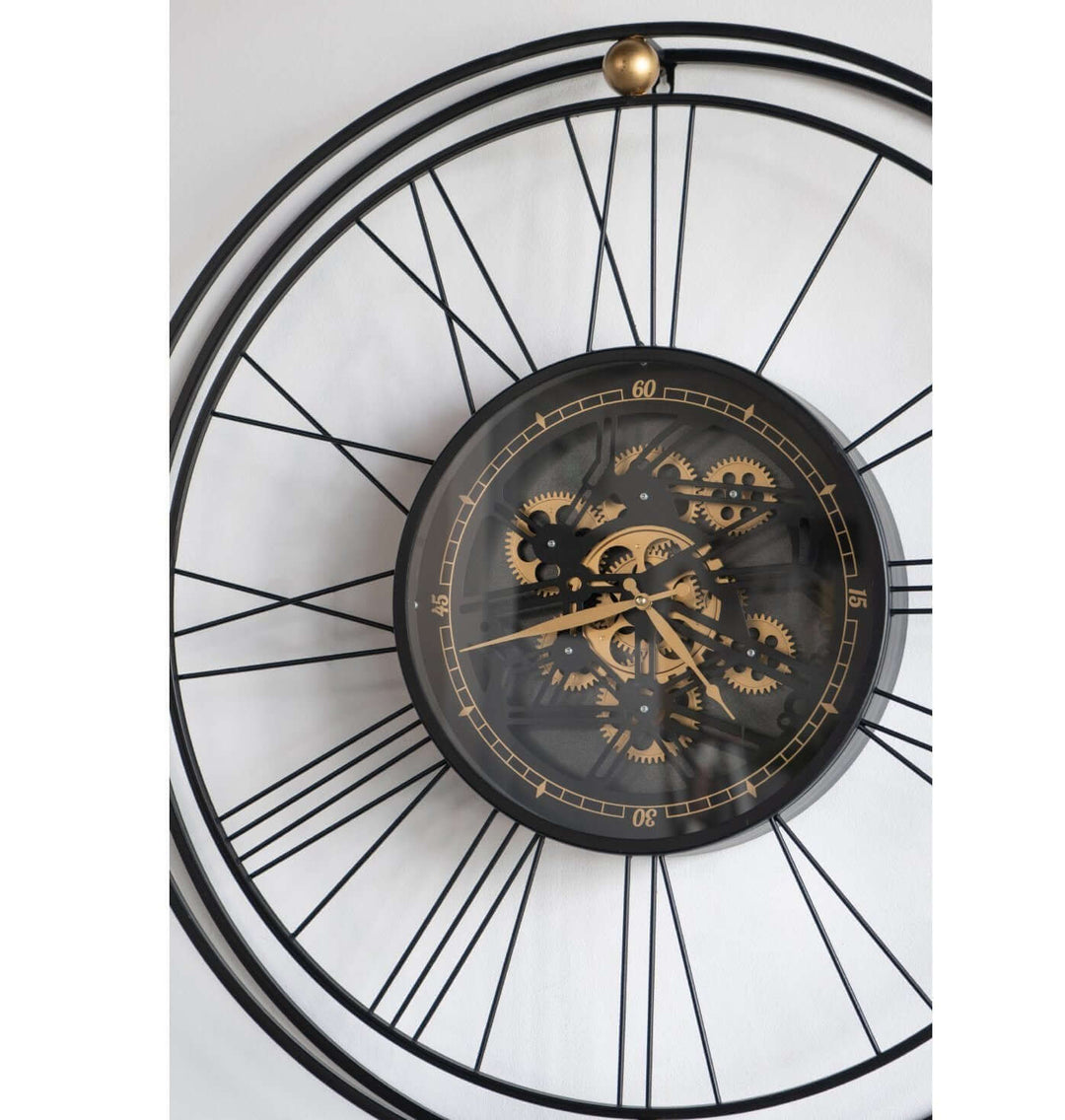 Traveler wall clock with moving 3D mechanism, featuring oversized Roman numerals and elegant mechanical gears.