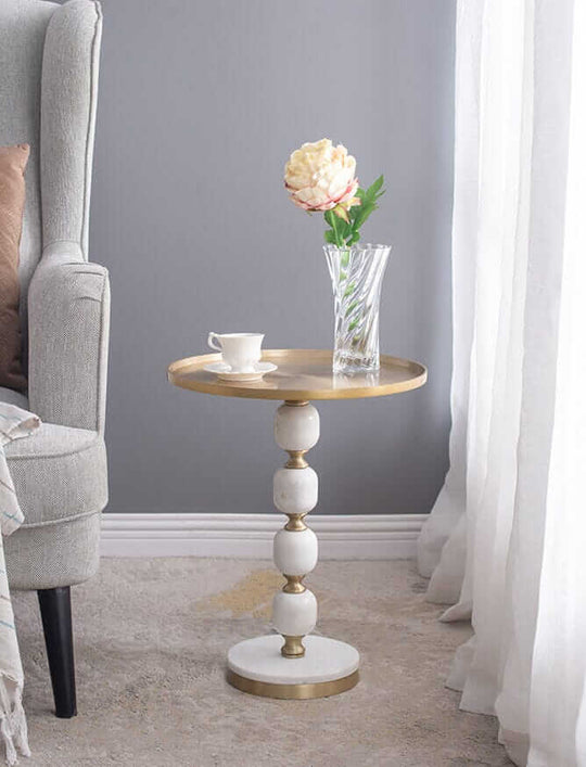 Elegant JESICCA marble and aluminium side table with flowers and cup in stylish living room setting. Affordable luxe design.