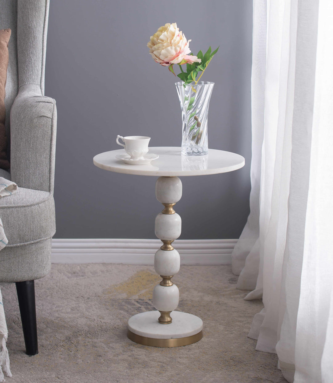 Handcrafted pebble marble and aluminum side table with floral vase, perfect for home decor. Affordable luxe design for any room.