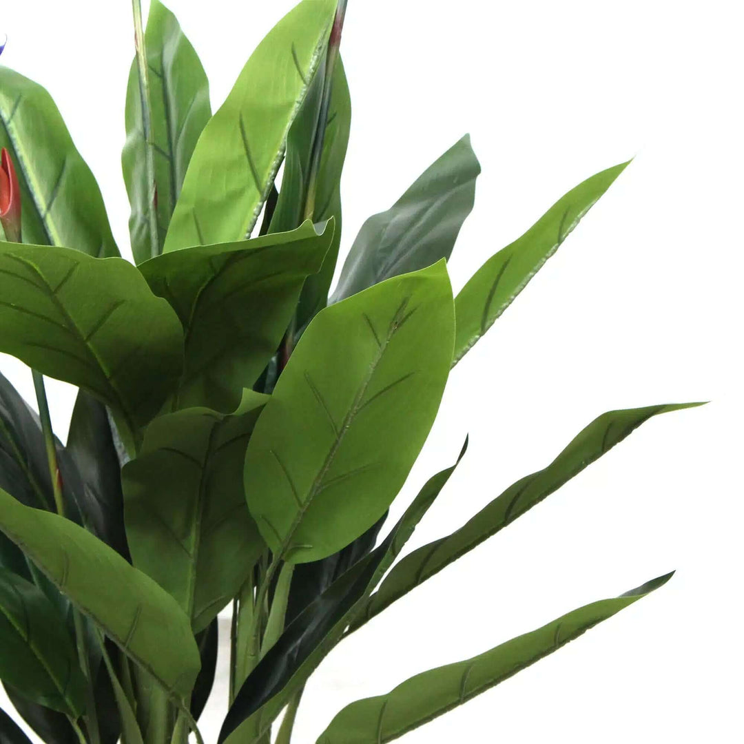 Artificial Bird of Paradise plant with vibrant red flowers and lush green leaves for a tropical home decor.