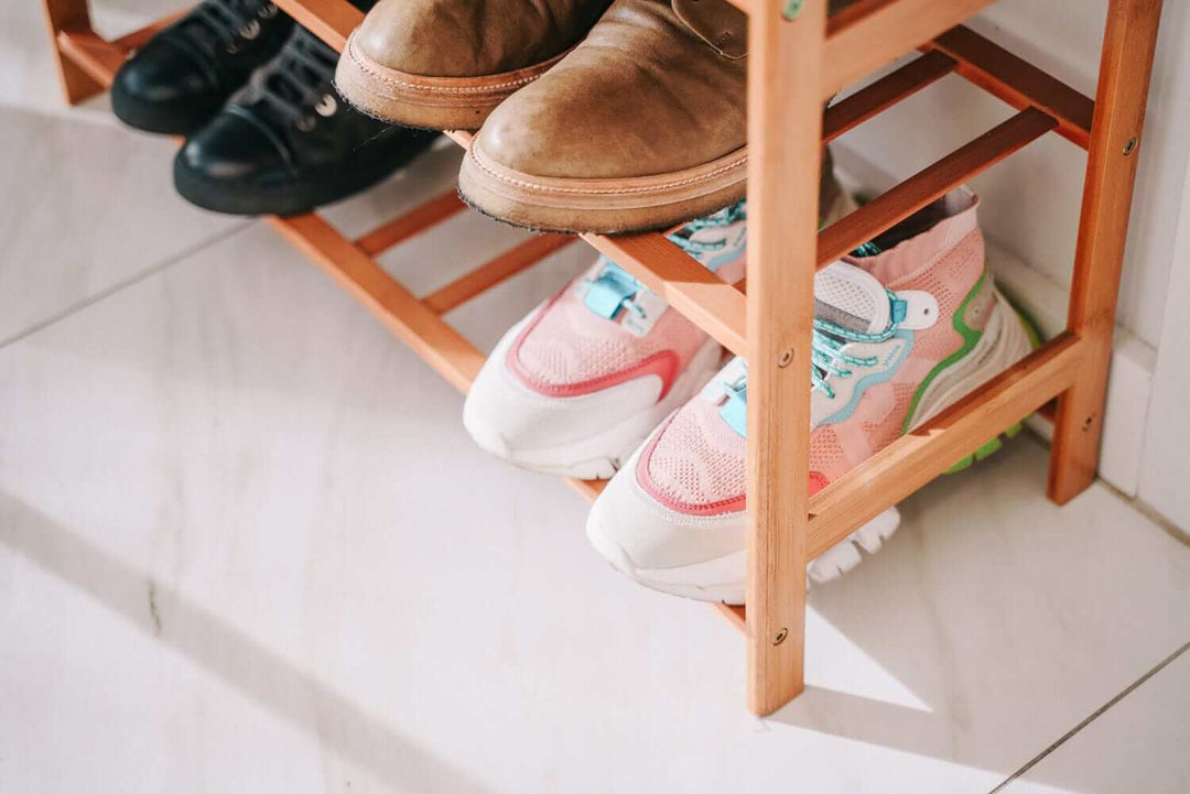 Stylish bamboo shoe rack displaying various types of shoes, enhancing home organization and modern aesthetics.