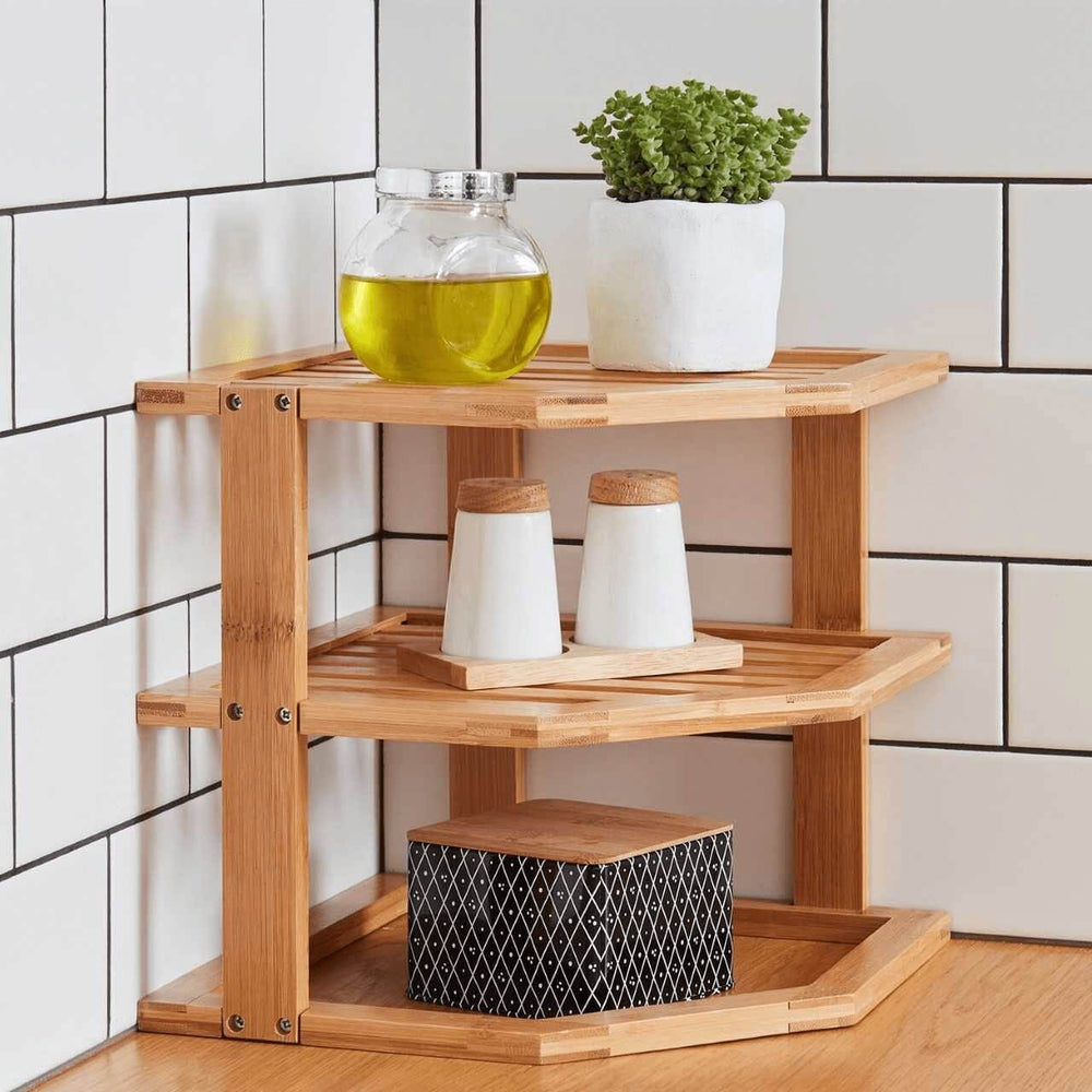 Affordable three-tier bamboo kitchen rack in corner, showcasing quality storage for dishware and decor items.