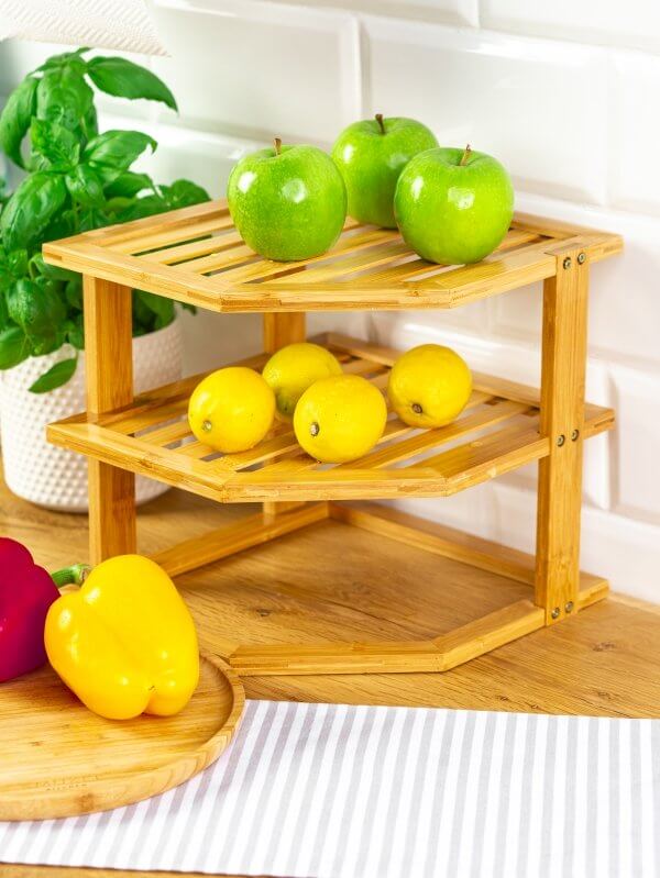 Three-tier bamboo kitchen rack displaying green apples and yellow lemons, enhancing kitchen storage and organization.