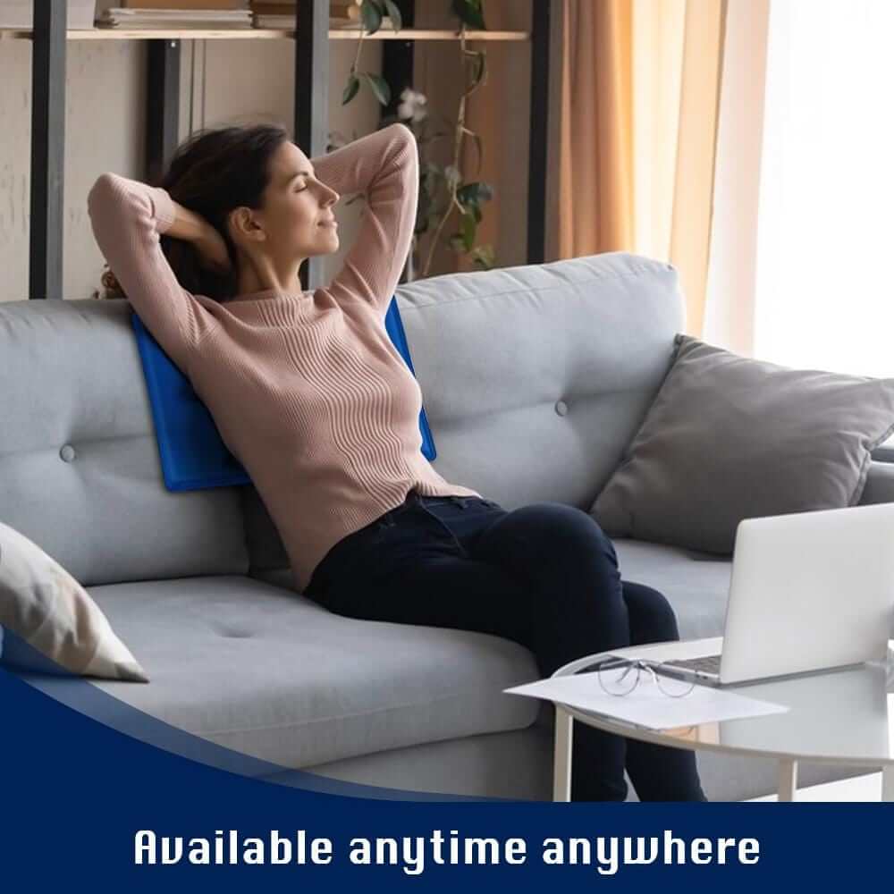 Woman relaxing on a couch with a cooling gel pillow, promoting affordable comfort and quality relief anytime, anywhere.